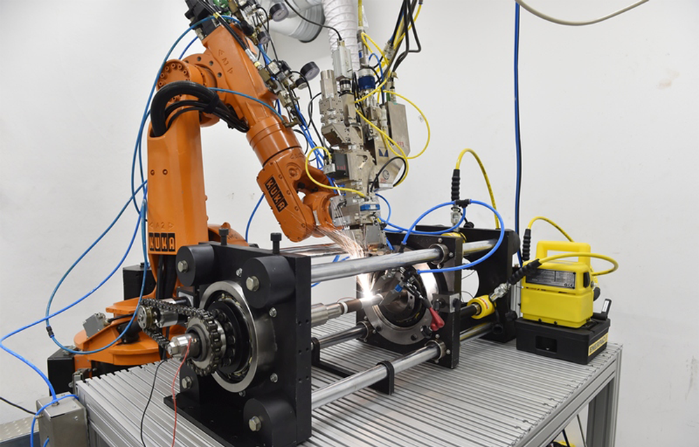 a robot arm welds a workpiece